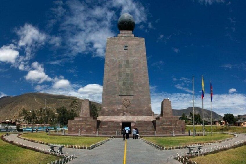 A monument with a spherical top, surrounded by a circular plaza with a pathway leading to it. 4