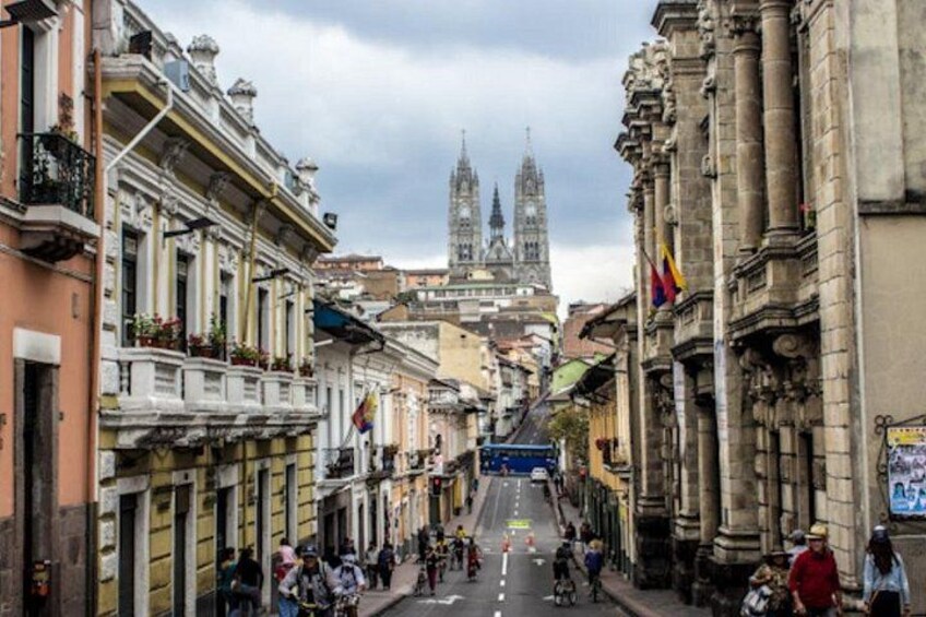 A street with buildings, a cathedral, and flags. 3