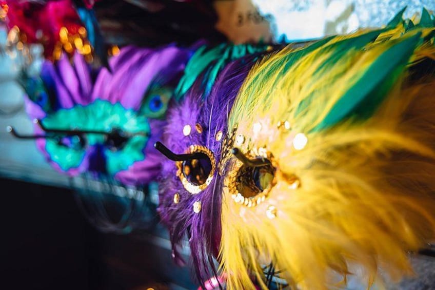 A colorful mask with a large eye and feather details. 4