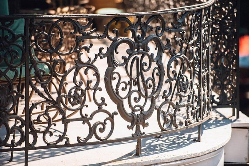 A wrought iron fence with intricate designs. 2