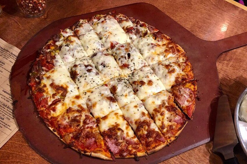 A pizza with cheese and pepperoni on a wooden table. 3