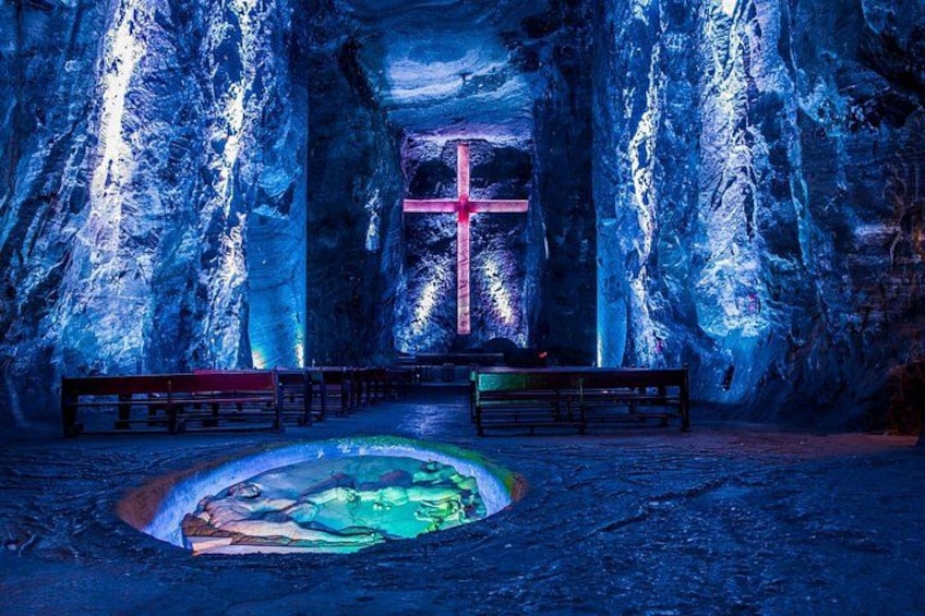 An ice cave with a cross and benches. 5