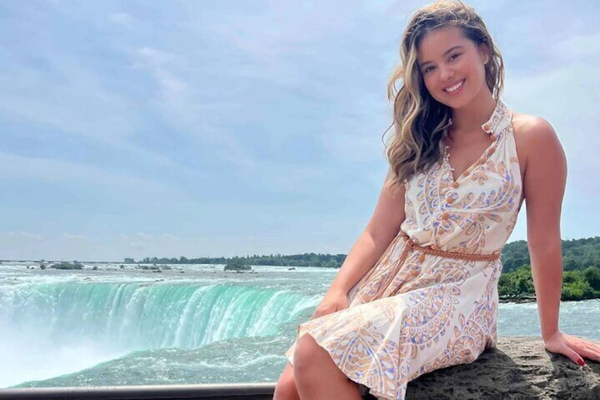 A person sitting by a waterfall. 4