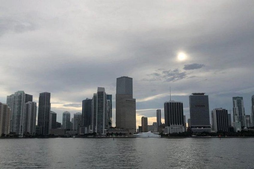 A city skyline with high-rise buildings and a body of water in the foreground. 2