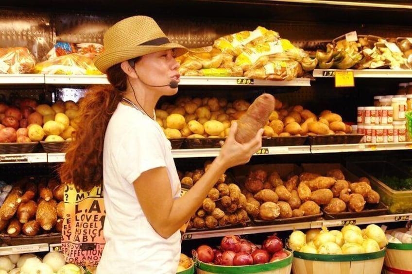 Una persona comprando en un pasillo de un supermercado, con diferentes verduras y papas. 1