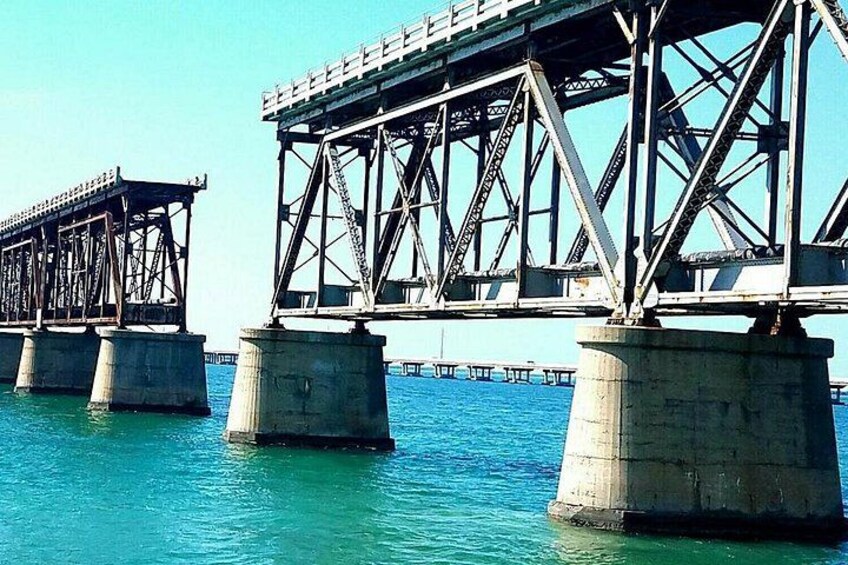 A steel bridge with multiple piers extending into a body of water. 3