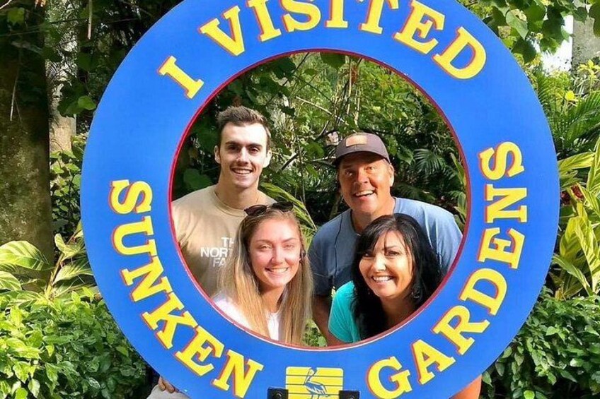 A circular sign with the text 'I VISITED SUNKEN GARDENS' and a photo of four people. 5