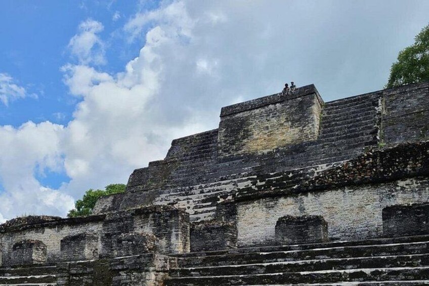 Ancient ruins with stepped structures and a flat-topped building. 4