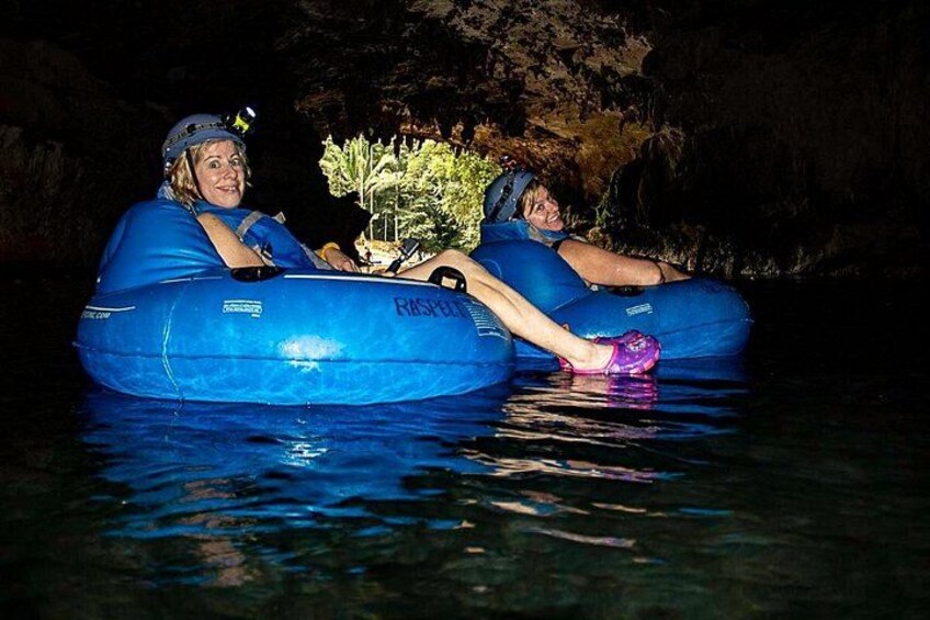 Two people in blue inflatable rafts on water. 4