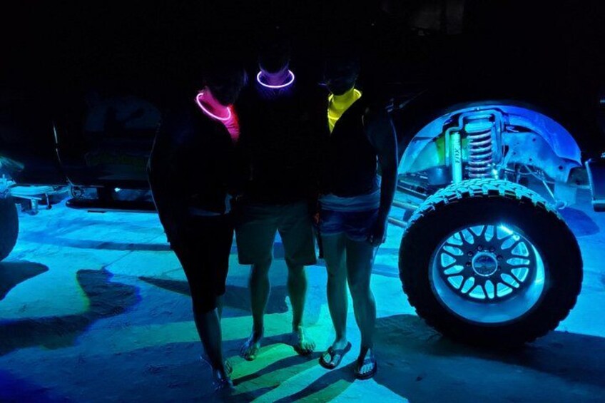 A person standing next to a vehicle with glowing wheels. 3