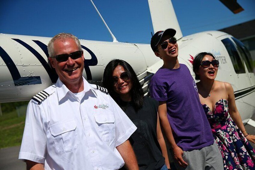 A group of people standing in front of an airplane. 3