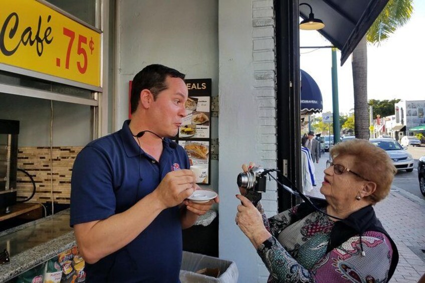Guest taking photo of guide as he explains tradition of Cuban coffee 2