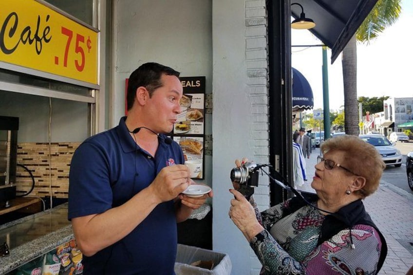 Guest taking photo of guide as he explains tradition of Cuban coffee 2