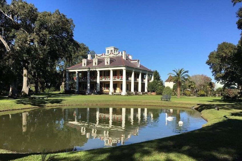 A large house with a pond in front. 1