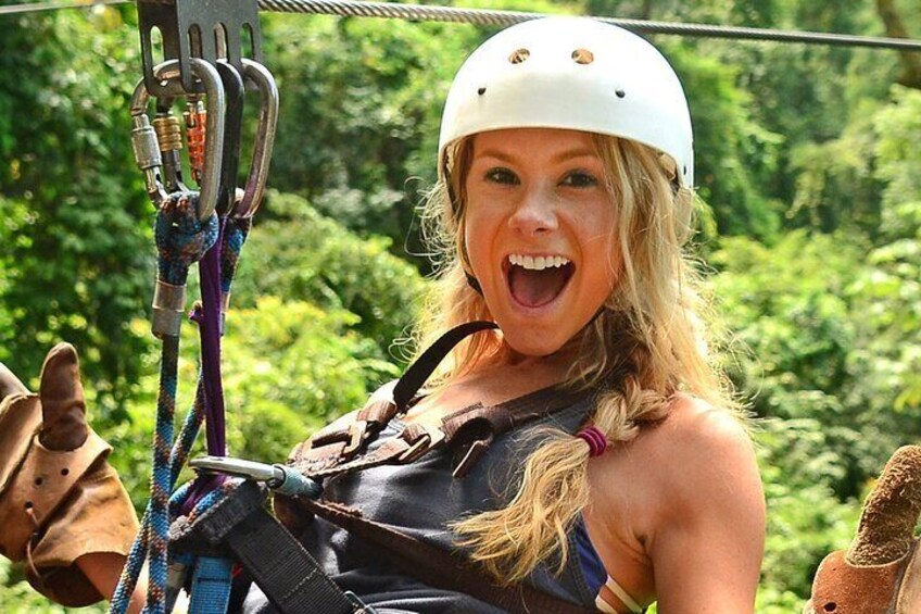 A person wearing a helmet and harness, preparing for ziplining. 1