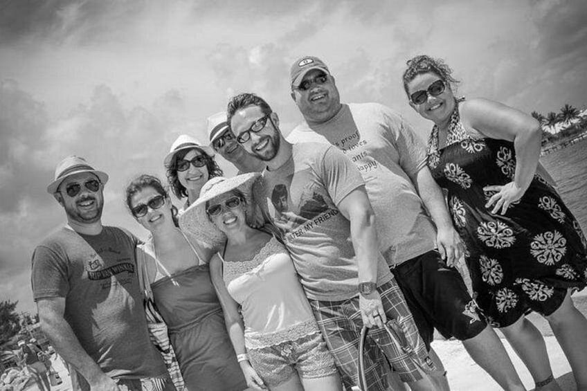 A group of people at a beach with a clear sky. 2