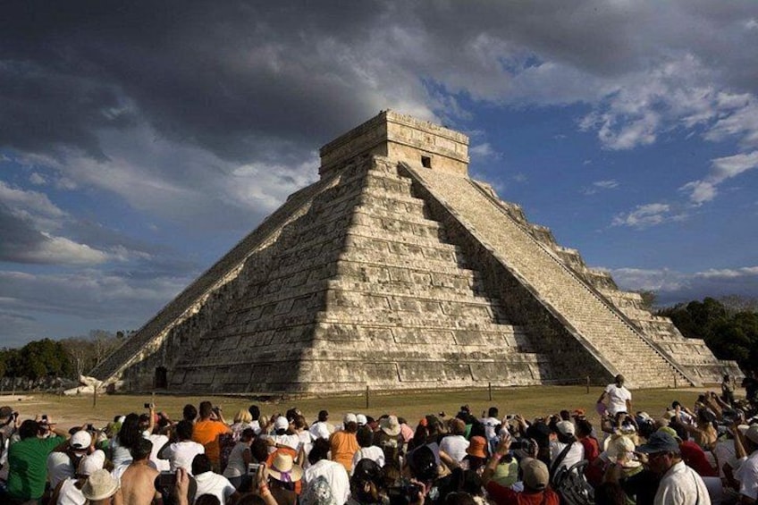 A large pyramid with a crowd of people in front. 5