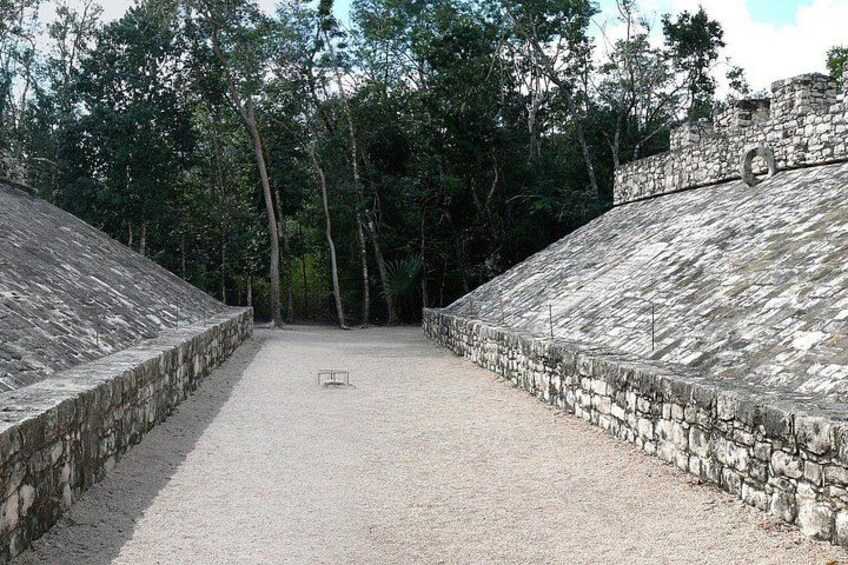 A stone structure with a flat top and a central pathway. 2