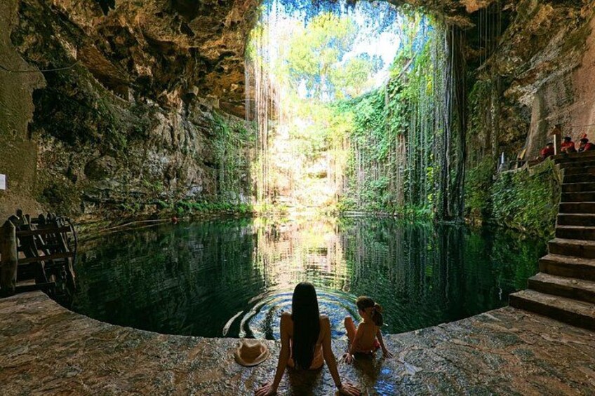 A cave with a waterfall, a pool of water, and a staircase leading up. 3