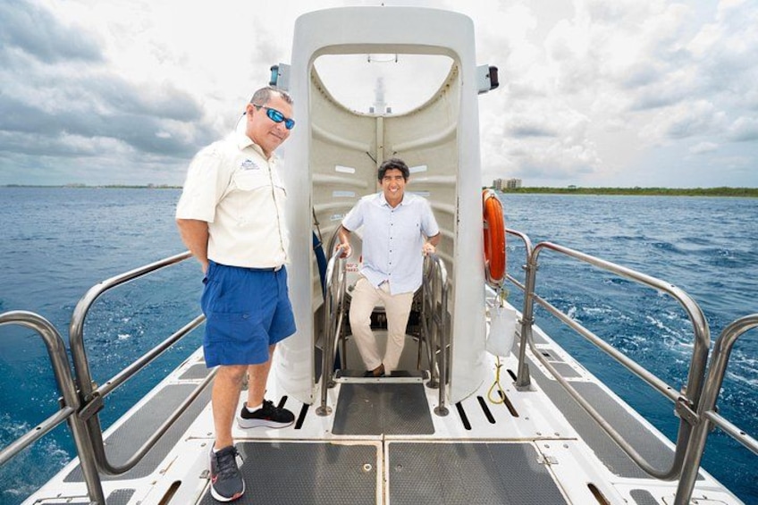 A boat with two people, one standing and one seated, on a body of water with a cloudy sky. 3