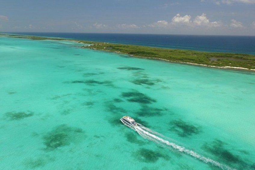 A boat on turquoise waters with a clear sky. 3