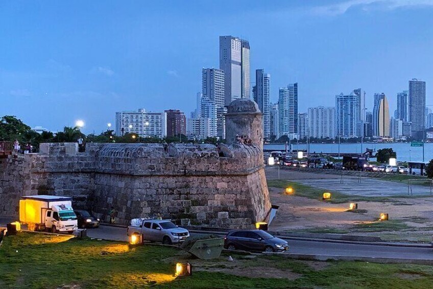 A historic fort with a city skyline in the background. 2