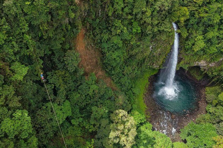 A waterfall surrounded by dense forest. 3