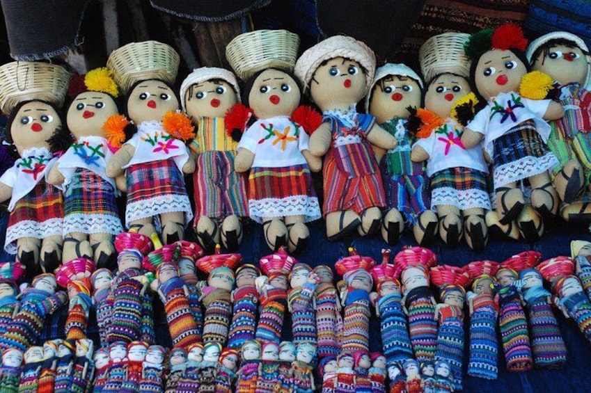 A collection of traditional dolls and colorful woven baskets. 4