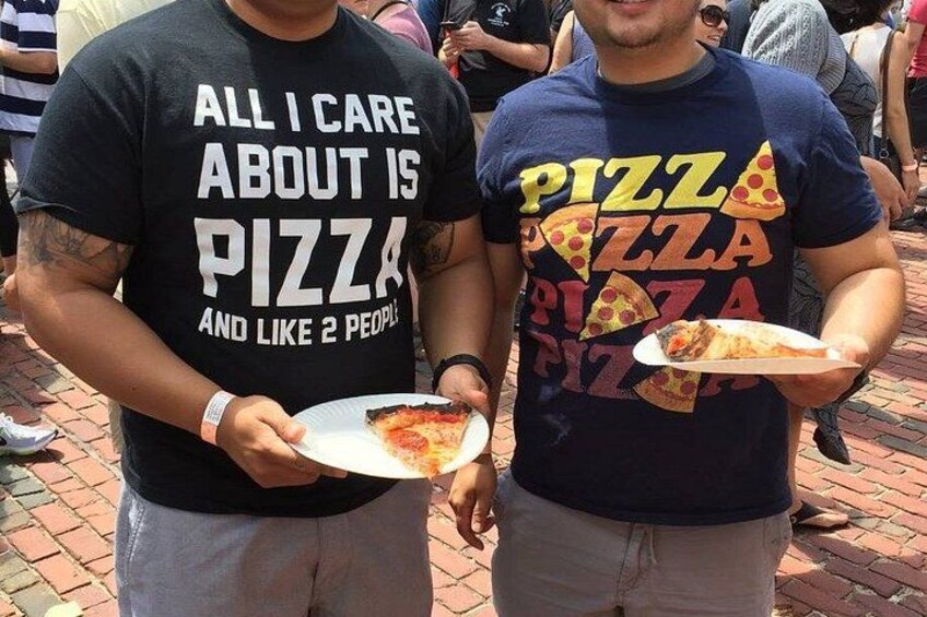 Two people holding plates of pizza. 4