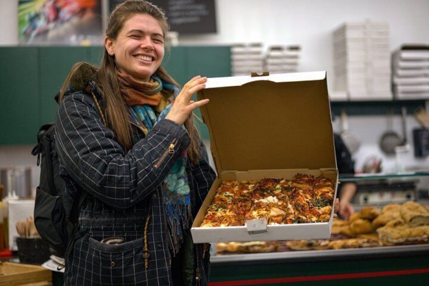 A person holding an open pizza box. 1
