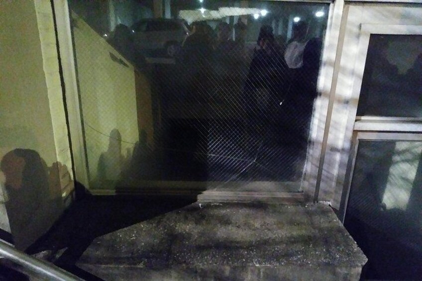 You can see that the couple in the glass was NOT outside but inside this locked condemned location! 3