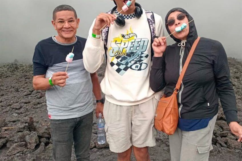 Three people standing on a rocky terrain with a water bottle and a bag. 3