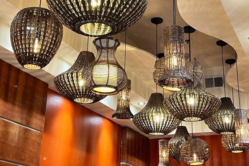 A collection of hanging, ribbed pendant lights with a warm glow. 3