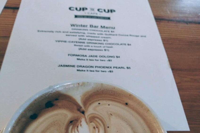 A menu with a coffee cup in the foreground. 5