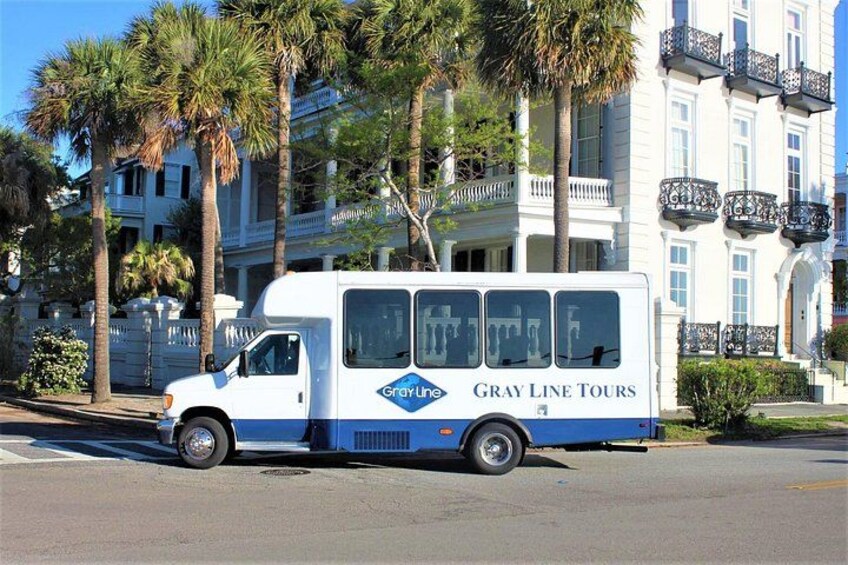 A white tour bus with 'Gray Line Tours' on the side parked on a street. 3