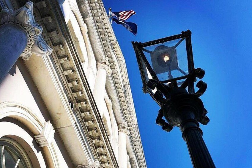 A street lamp, a building with classical architecture, and an American flag. 5