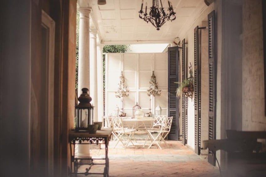 A dining area with a table and chairs, a chandelier, and a view of the outdoors. 2