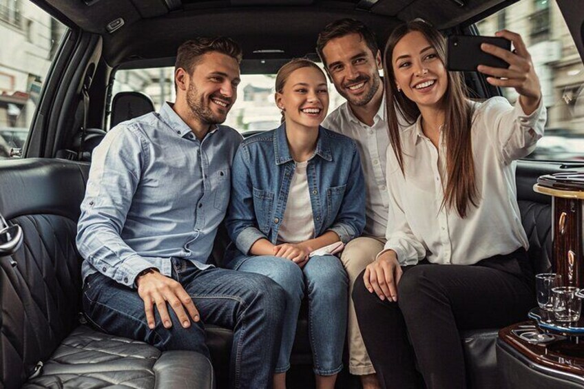 Four people sitting in a car, taking a selfie. 1