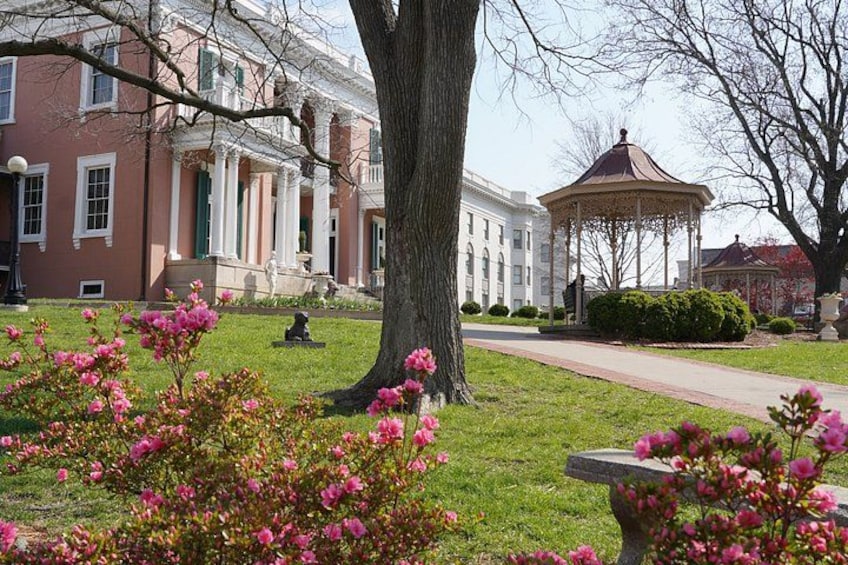 A large tree, a gazebo, and a building with columns. 5
