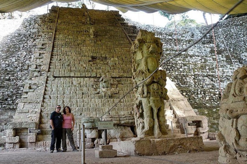 An ancient stone structure with a large carved figure and a staircase. 2