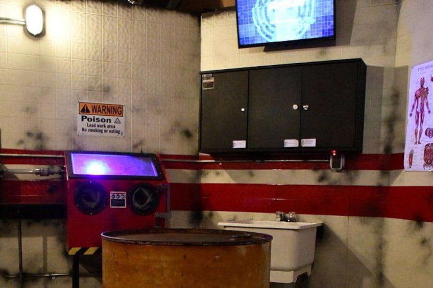 A laboratory with a warning sign for poison, a sink, and a cabinet. 4
