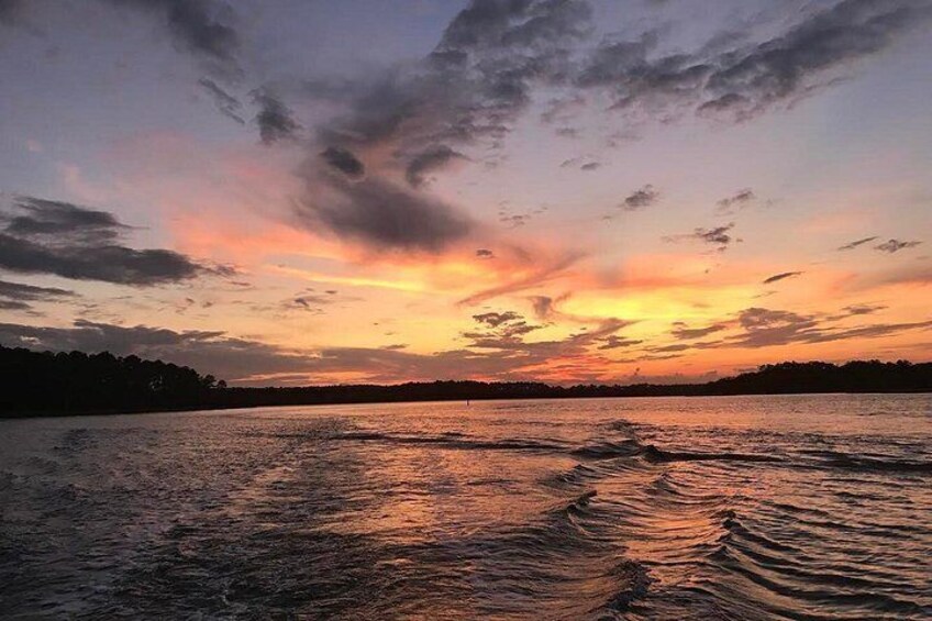 A sunset over a body of water with ripples on the surface. 5