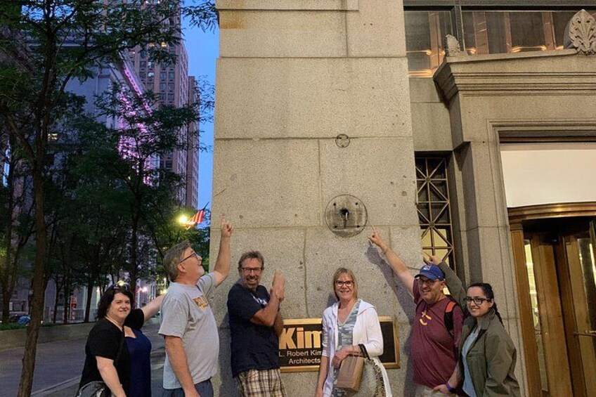 A group of people standing in front of a building with a sign that reads 'Kirkland Architects.' 2