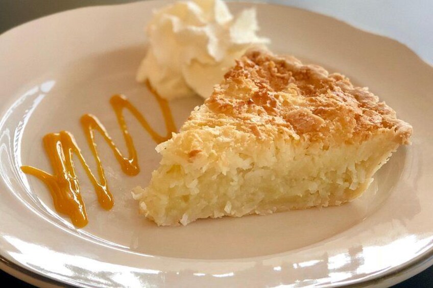 A slice of pie with caramel sauce on a plate. 2