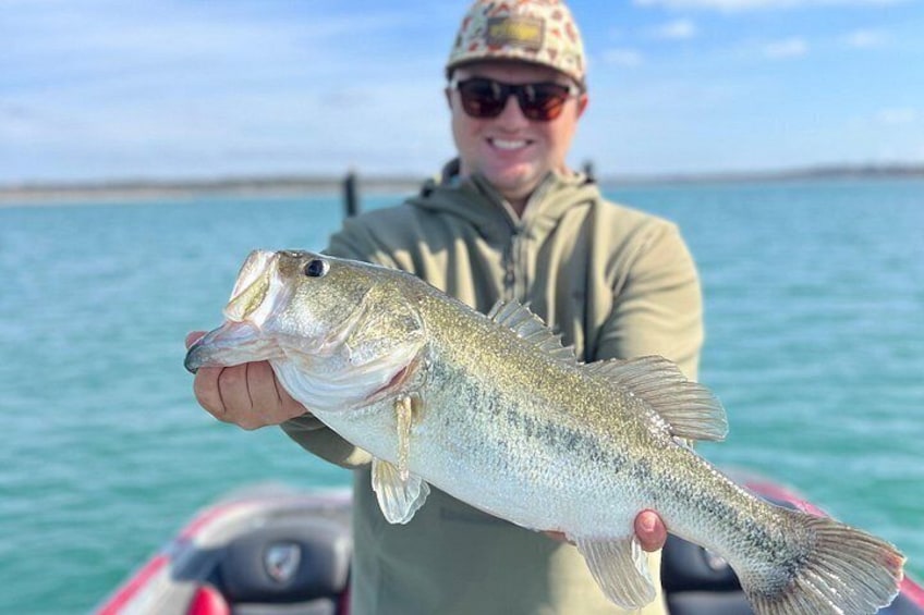 A person holding a fish on a boat. 3