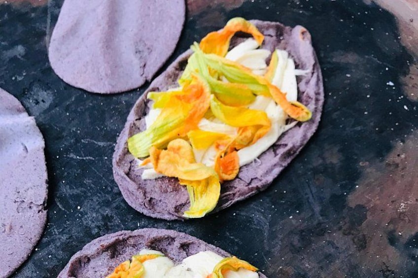 Tortillas with toppings on a dark surface. 1