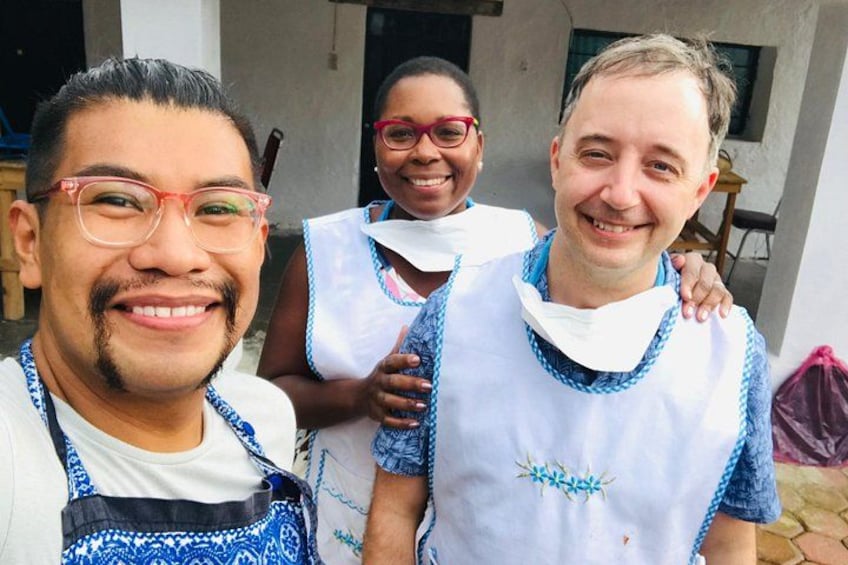 Three people wearing white and blue patterned shirts with a white collar. 3