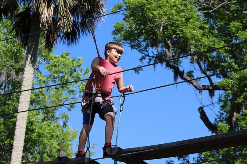 Move from tree to tree on obstacles like hanging bridges. 2