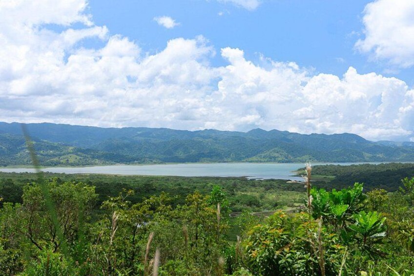 A lake surrounded by mountains and lush greenery. 4