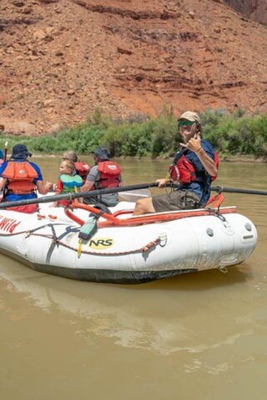 A group of people in a white inflatable raft on a river. 2